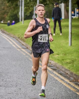 A runner's legs, in the rain on a warm day
